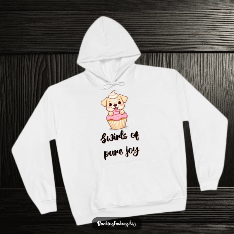 Funny hoodie of a small dog happily frosting a cupcake with a beautifully swirled topping, perfect for comfortable, cozy wear.