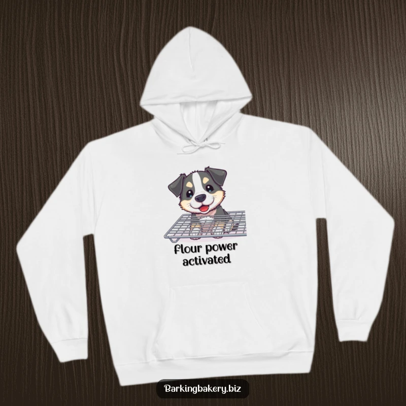 Funny Curious Dog Hoodie: A flour-smudged dog joyfully sniffs a cooling rack, offering cozy humor and baking charm.