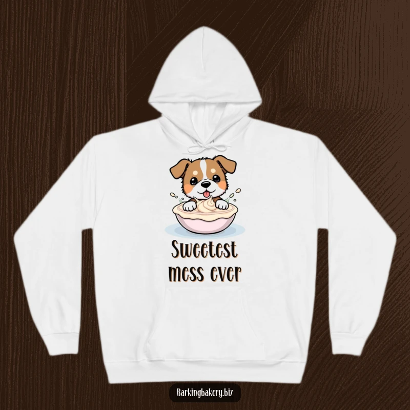Funny hoodie depicting a gleeful dog enthusiastically splashing and playing inside a large container of sweet frosting.