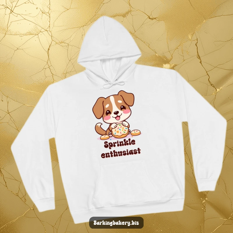 Funny hoodie print of a dog excitedly decorating a cookie with sprinkles, tail wagging energetically.