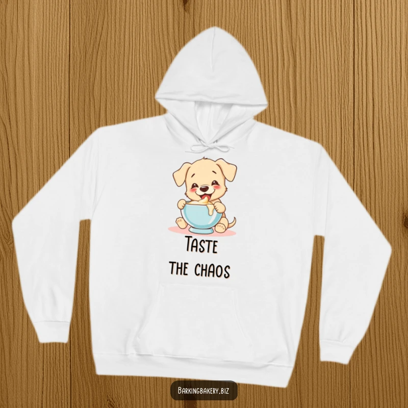 Funny puppy joyfully tastes batter from a mixing bowl, creating a cozy and humorous hoodie design.
