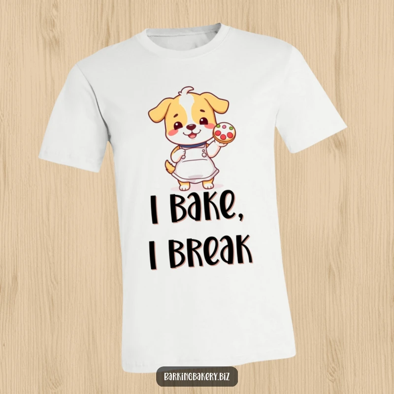 Funny dog wearing an apron proudly holds up a decorated cookie on a funny t-shirt.