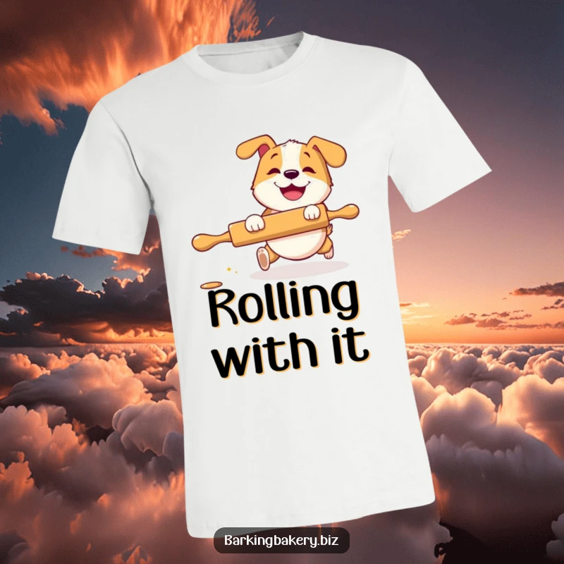 Funny T-Shirt: A dog with a big grin playfully chases a rolling pin, showcasing a moment of energetic and humorous baking fun.
